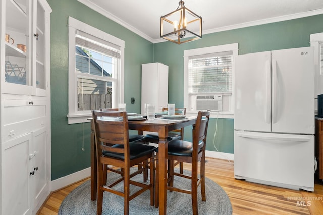 907 3rd St, Lewiston, ID 83501 - dining area featuring light wood-type flooring, a chandelier, crown molding, and cooling unit