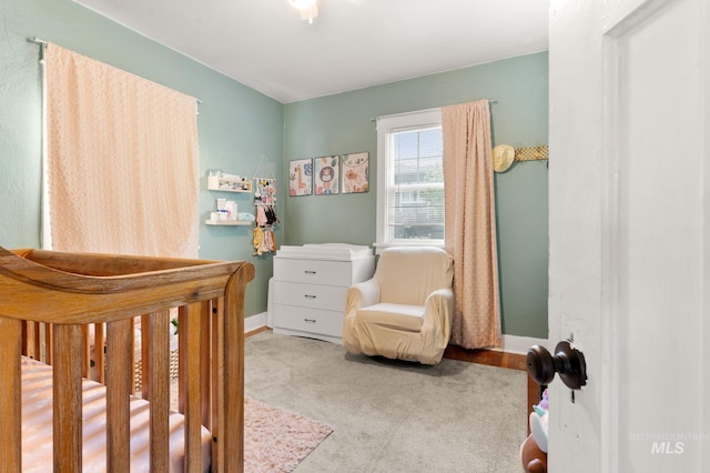 907 3rd St, Lewiston, ID 83501 - carpeted bedroom with baseboards and a crib
