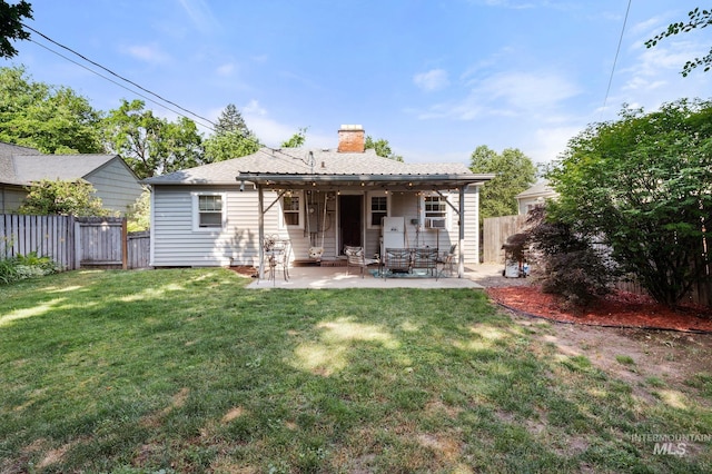 907 3rd St, Lewiston, ID 83501 - back of house with a chimney, a fenced backyard, and a patio