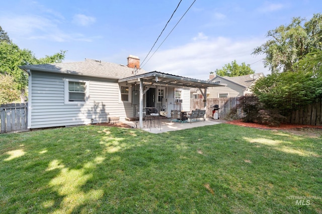907 3rd St, Lewiston, ID 83501 - rear view of house featuring a patio, a chimney, and a fenced backyard