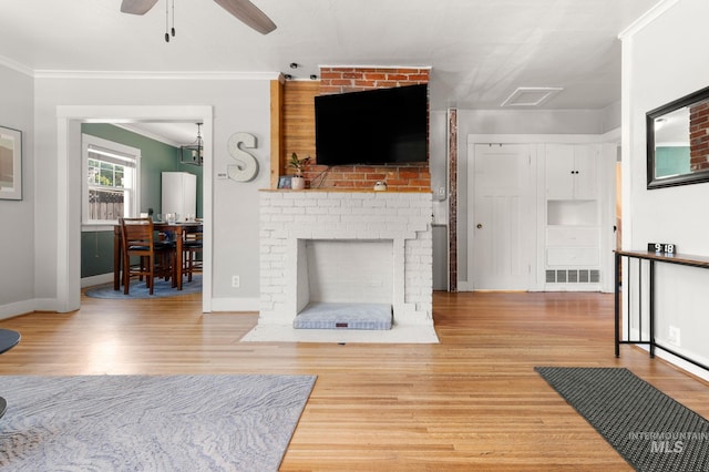 907 3rd St, Lewiston, ID 83501 - living area featuring wood finished floors, crown molding, ceiling fan, and a fireplace