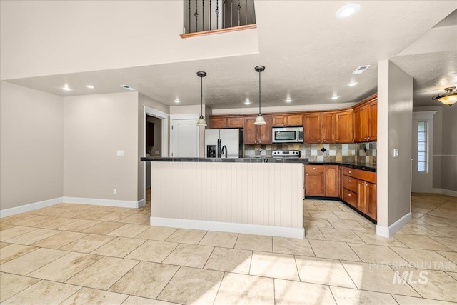 2476 S Amaya Ln, Boise, ID 83709 - kitchen with appliances with stainless steel finishes, dark countertops, recessed lighting, decorative backsplash, and brown cabinetry