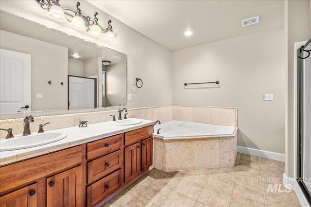 2476 S Amaya Ln, Boise, ID 83709 - bathroom featuring tile patterned flooring, a bath, a stall shower, and double vanity
