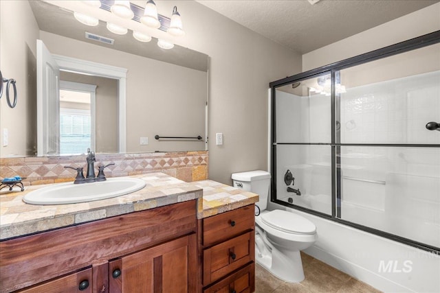 2476 S Amaya Ln, Boise, ID 83709 - bathroom with vanity, toilet, shower / bath combination with glass door, tile patterned floors, and a textured ceiling