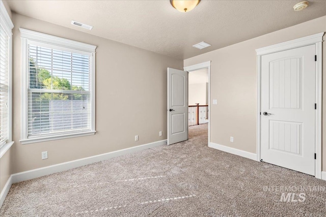 2476 S Amaya Ln, Boise, ID 83709 - unfurnished bedroom featuring carpet flooring, baseboards, and a textured ceiling