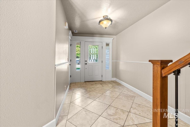 2476 S Amaya Ln, Boise, ID 83709 - entrance foyer with baseboards, a textured ceiling, and light tile patterned flooring