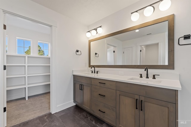 2358 E Monhegan Dr, Eagle, ID 83616 - bathroom featuring double vanity, marble finish flooring, baseboards, and a closet