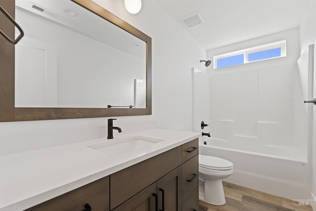 2358 E Monhegan Dr, Eagle, ID 83616 - full bathroom with vanity, toilet, wood finished floors, and tub / shower combination