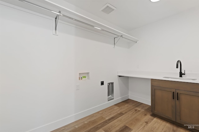 2358 E Monhegan Dr, Eagle, ID 83616 - washroom with cabinet space, hookup for a washing machine, baseboards, light wood-style floors, and hookup for an electric dryer