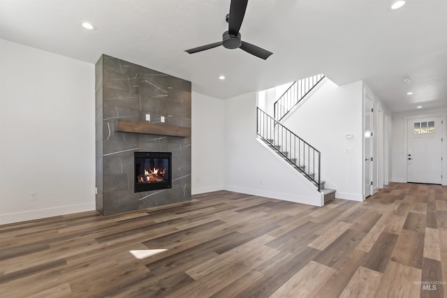 2358 E Monhegan Dr, Eagle, ID 83616 - unfurnished living room with a ceiling fan, recessed lighting, baseboards, stairway, and wood finished floors