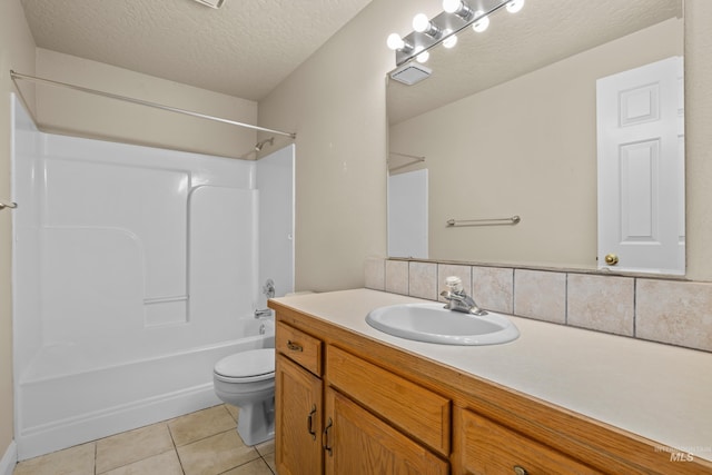 full bathroom with vanity,  shower combination, toilet, tile patterned floors, and a textured ceiling