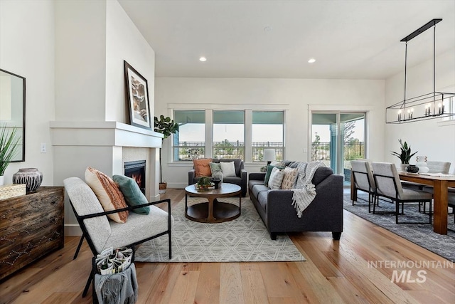 living room featuring hardwood / wood-style flooring, a chandelier, and plenty of natural light