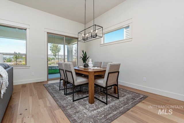 dining room featuring hardwood / wood-style floors and an inviting chandelier