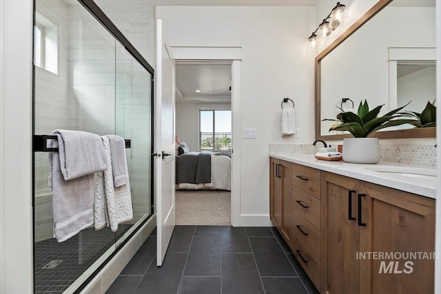 bathroom with tile patterned flooring, a shower with shower door, and vanity