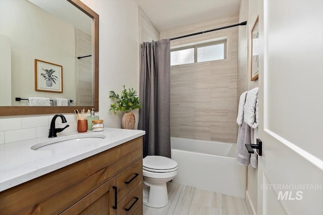 full bathroom featuring toilet, shower / tub combo, and vanity