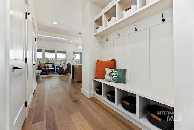 mudroom with light hardwood / wood-style floors