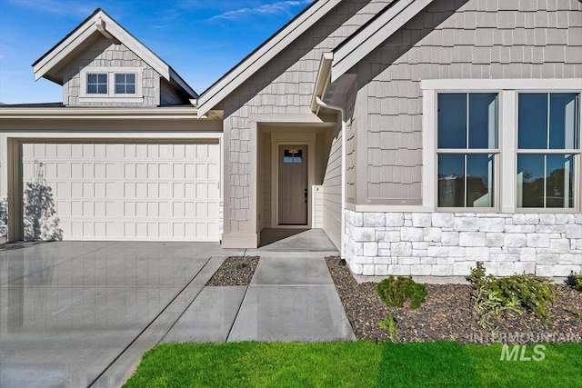 doorway to property with a garage