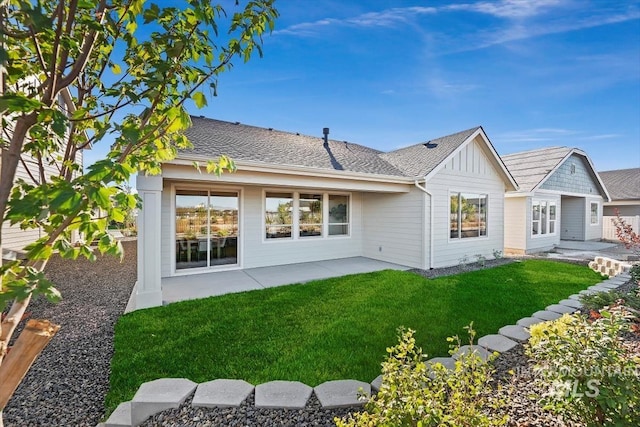 rear view of property with a yard and a patio