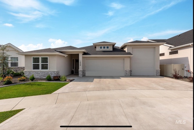 prairie-style home featuring a garage and a front lawn