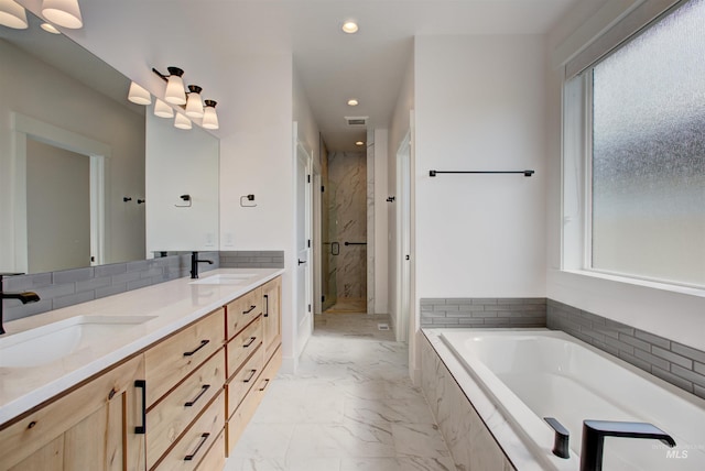 bathroom with vanity and separate shower and tub