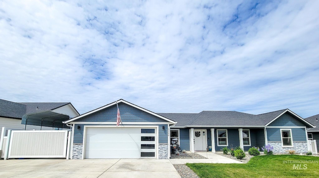 3220 Parkridge Way, Lewiston, ID 83501 - view of front facade with stone siding, driveway, a garage, and a carport