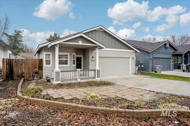 view of front facade with covered porch, central AC unit, and a garage