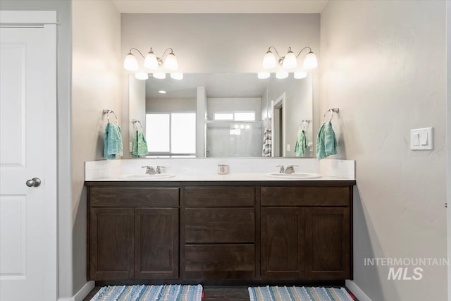 22924 Fargo Rd, Parma, ID 83660 - full bath featuring double vanity, baseboards, and a sink