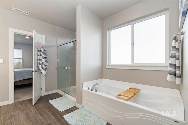 22924 Fargo Rd, Parma, ID 83660 - bathroom featuring connected bathroom, visible vents, wood finished floors, and a stall shower
