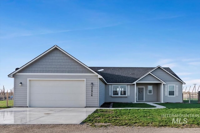 22924 Fargo Rd, Parma, ID 83660 - ranch-style house with driveway, an attached garage, a shingled roof, and a front lawn