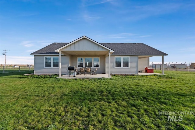 22924 Fargo Rd, Parma, ID 83660 - rear view of property with board and batten siding, a yard, and a patio area