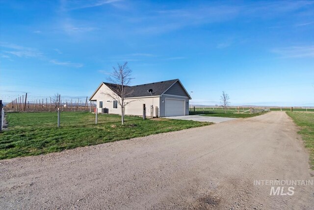 22924 Fargo Rd, Parma, ID 83660 - view of side of property featuring a lawn, an attached garage, fence, and concrete driveway