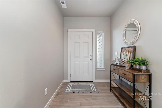 22924 Fargo Rd, Parma, ID 83660 - foyer with baseboards, visible vents, and wood tiled floor