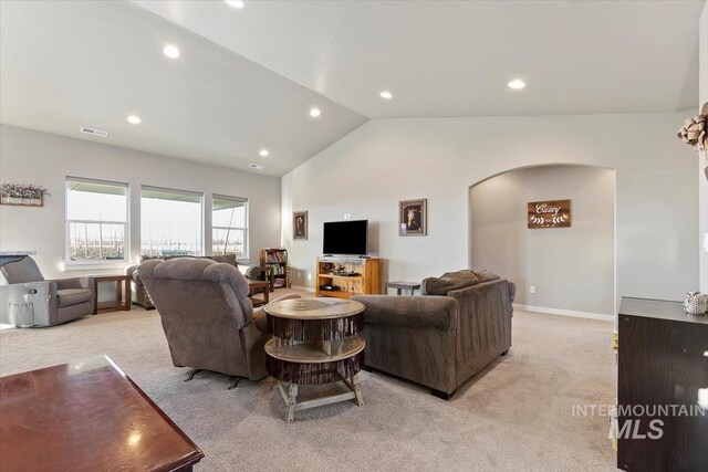 22924 Fargo Rd, Parma, ID 83660 - living room featuring arched walkways, light carpet, lofted ceiling, and recessed lighting
