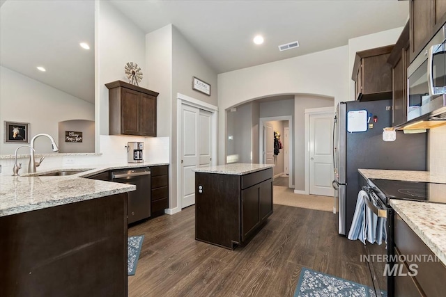 22924 Fargo Rd, Parma, ID 83660 - kitchen featuring a sink, arched walkways, visible vents, dark brown cabinets, and appliances with stainless steel finishes