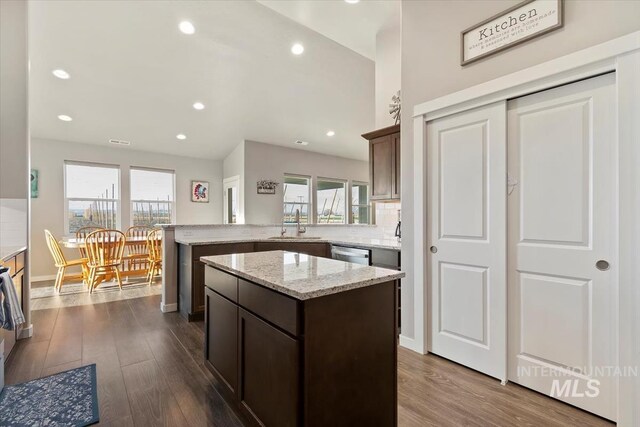 22924 Fargo Rd, Parma, ID 83660 - kitchen with a sink, light stone countertops, a peninsula, stainless steel dishwasher, and dark wood-style floors