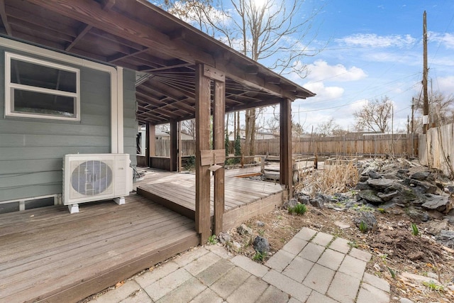 wooden terrace featuring ac unit and fence