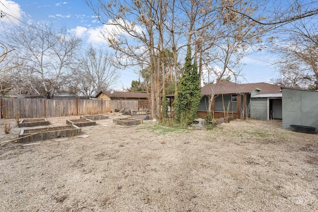 view of yard with a vegetable garden and fence