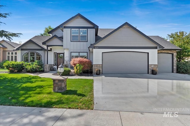 craftsman inspired home featuring a garage, concrete driveway, stone siding, board and batten siding, and a front yard