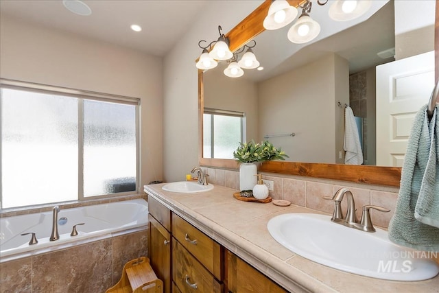 full bathroom with a garden tub, a sink, and double vanity