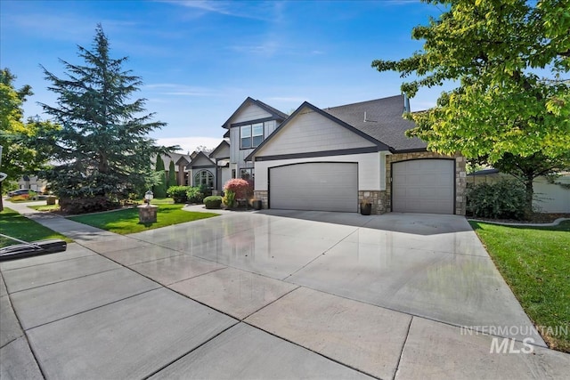 view of front facade featuring concrete driveway, a front lawn, an attached garage, and stone siding