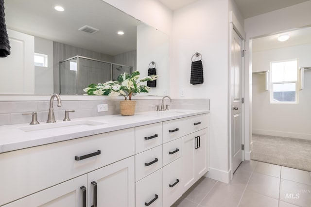 bathroom with double vanity, tile patterned flooring, a sink, and visible vents