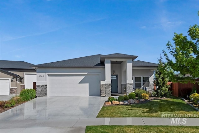 prairie-style house featuring a front lawn, concrete driveway, an attached garage, stone siding, and stucco siding