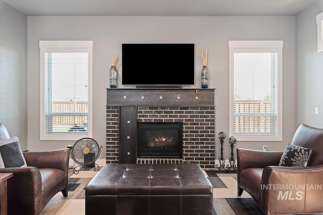 living area featuring a brick fireplace