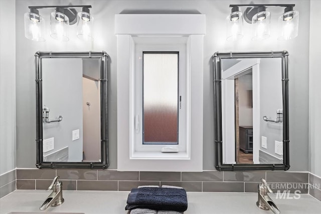 bathroom with decorative backsplash and a sink
