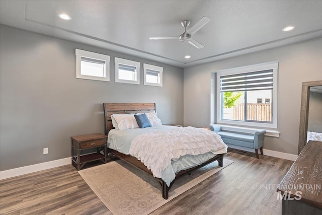 bedroom with baseboards, recessed lighting, and wood finished floors