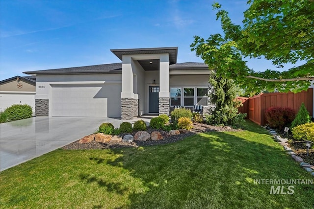 prairie-style home with fence, an attached garage, stone siding, stucco siding, and driveway