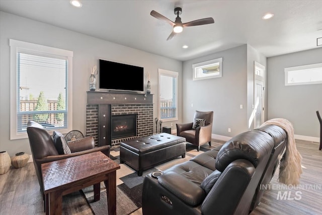 living area with a healthy amount of sunlight, a ceiling fan, recessed lighting, and wood finished floors