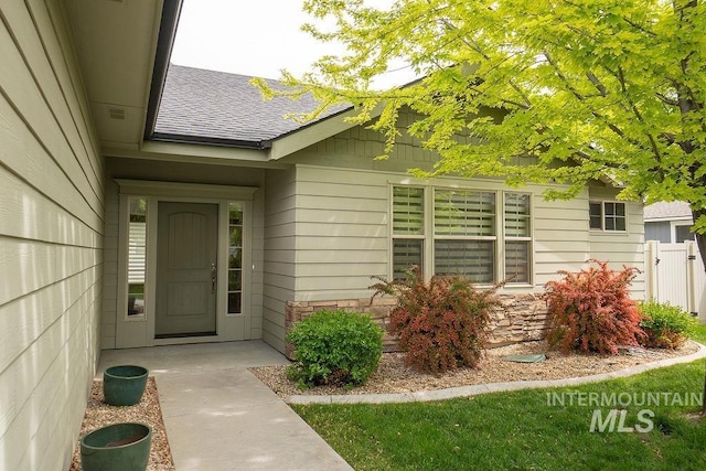 7053 W Butte Ln, Boise, ID 83704 - doorway to property featuring roof with shingles