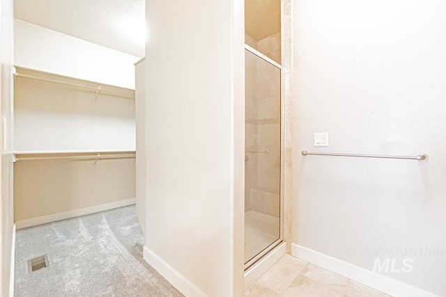 7053 W Butte Ln, Boise, ID 83704 - full bath featuring a stall shower, a spacious closet, and baseboards