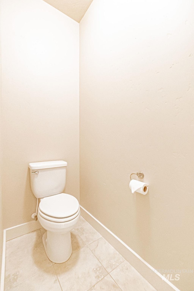 7053 W Butte Ln, Boise, ID 83704 - bathroom with toilet, baseboards, and tile patterned flooring